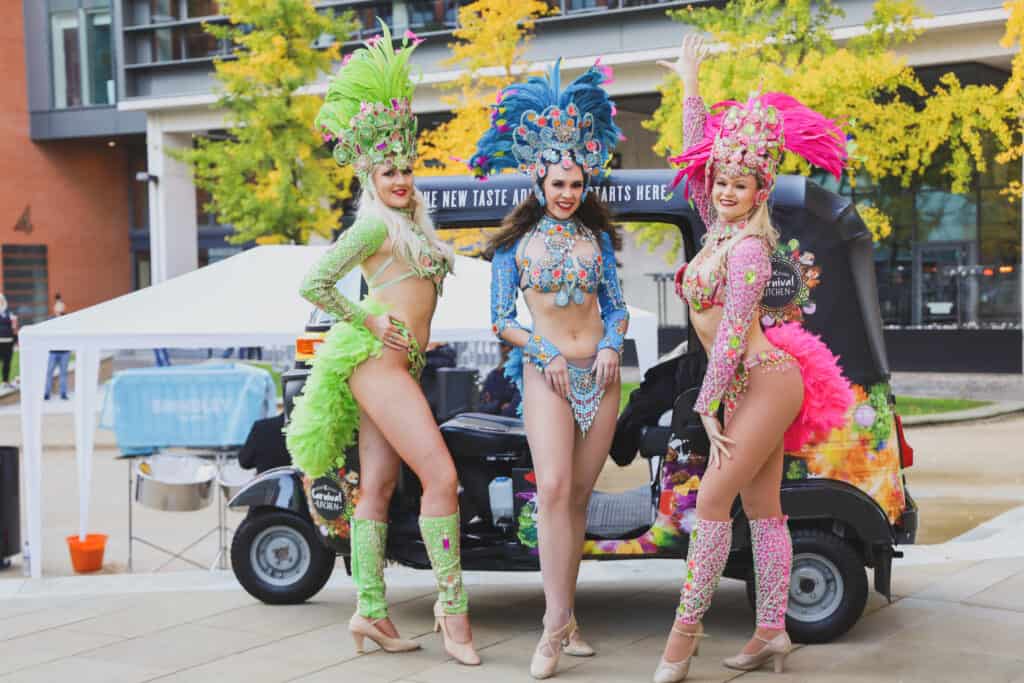 Carnival dancers and tuk tuk