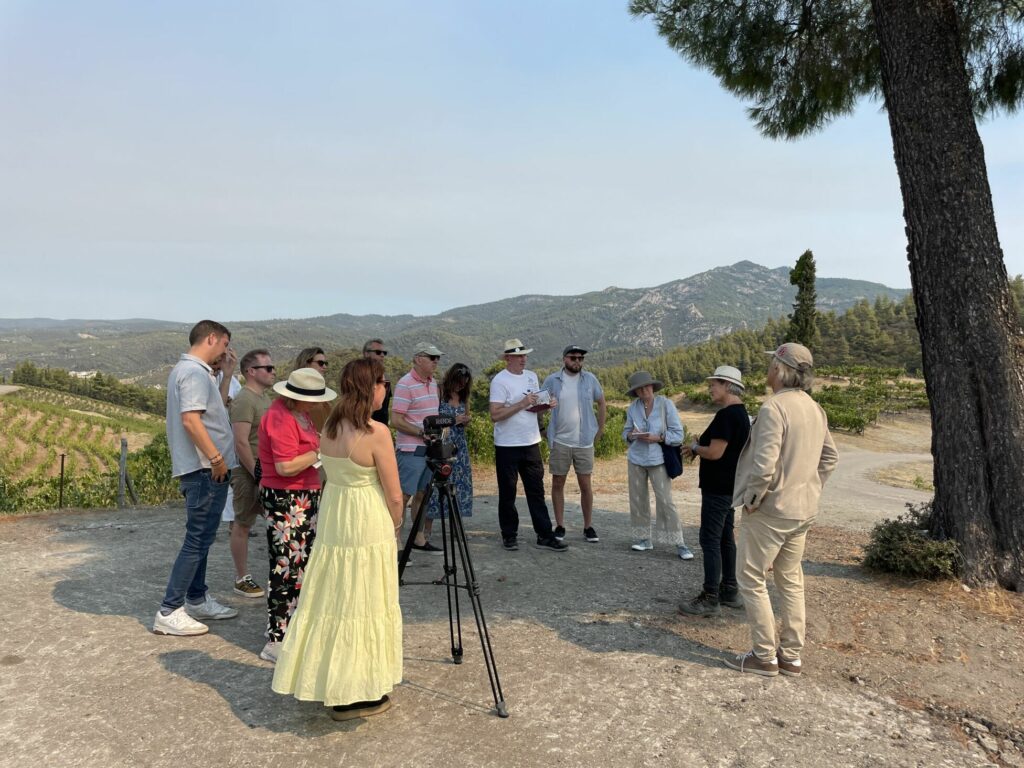 Group of journalists talking in vineyard